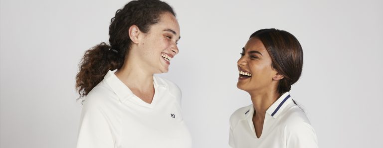 female cricketers laughing