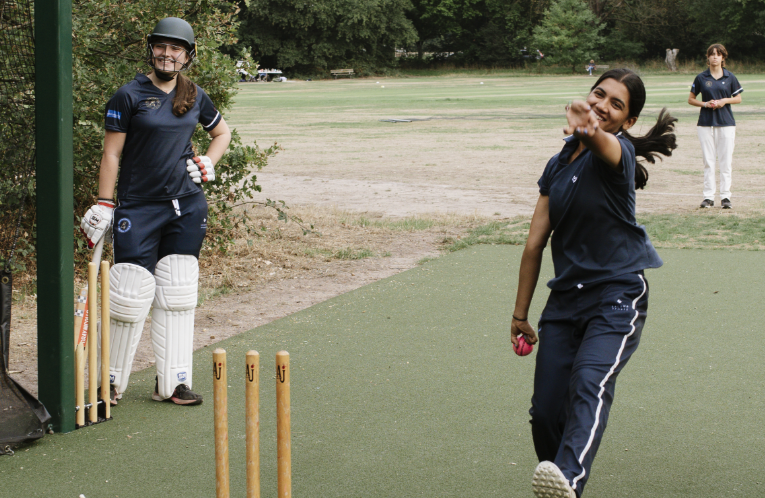 girl bowling a cricket ball