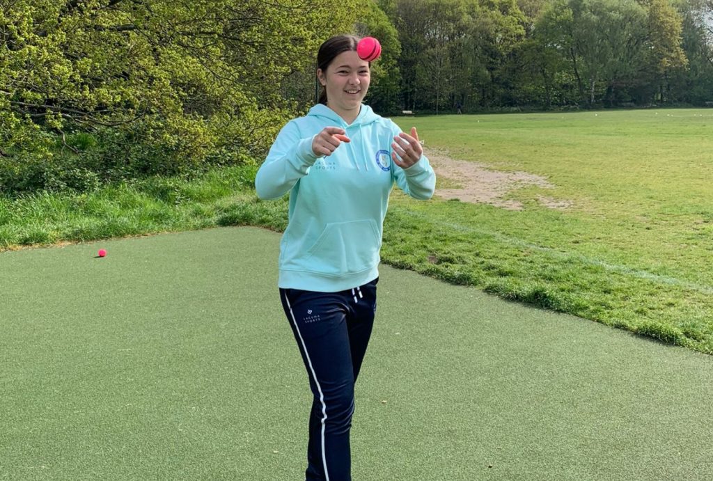 female cricket player catching a ball