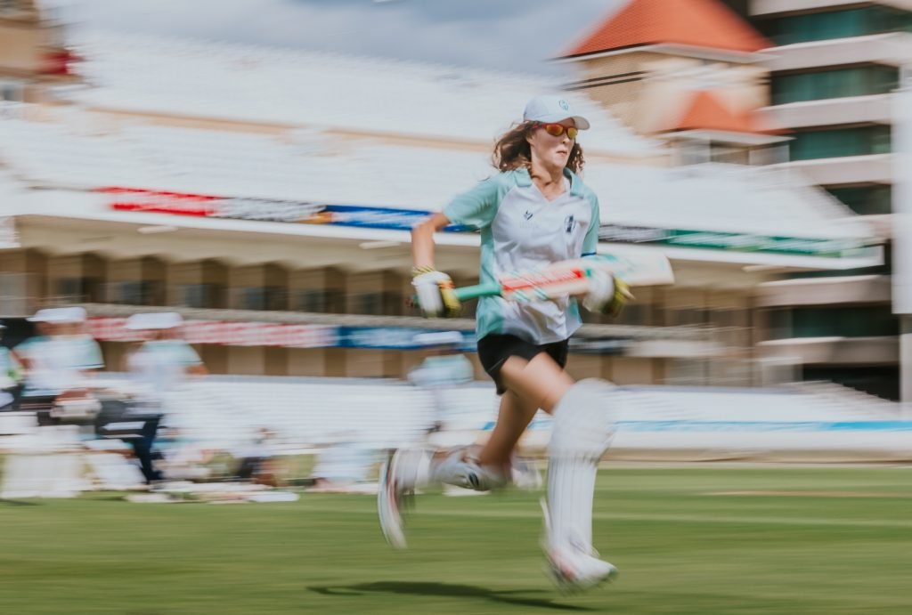 female cricket player running out on to the pitch